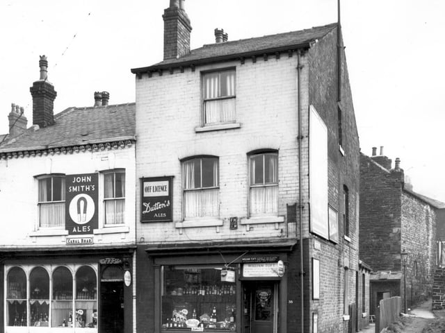 Two off licences located side-by-side on Canal Road in February 1964. On the left is Herbert Steeles and William Toft's. Far left, part of Pickering Street can be glimpsed and Delph Hill is on the right.