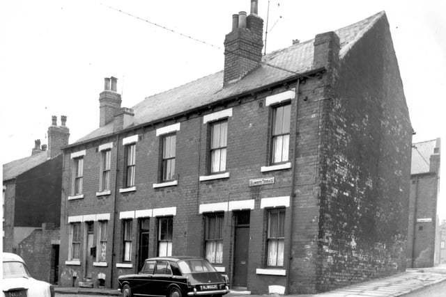 Three double fronted back-to-back terraced houses on Elsworth Terrace in February 1968. On the left is the original yard built to house shared outdoor toilets before the advent of indoor plumbing. On the right is Parliament Road.