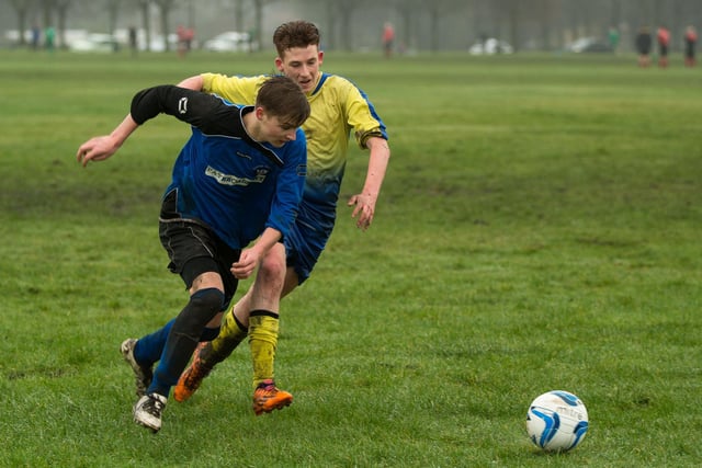 Adam Burke and Ashley Drake challenge during the clash between Fountain Head and Ryburn Valley at Savile Park.