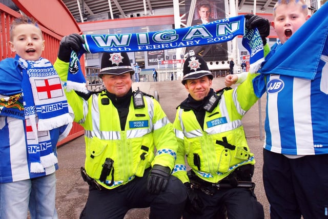 Connor Robinson and John Banks get support from Sgt Paul Mahoney and PC Lee Webber at the Carling Cup Final.