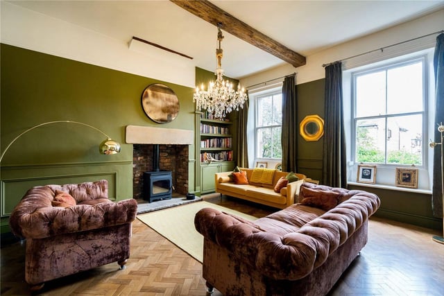 Also on this floor is the main reception room, again with parquet flooring and painted in a striking olive green.