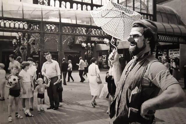 This is 'Albert the Idiot' alias Ian Scott Owens who was entertaining crowds with an endearing mixture of clown, puppeteer, balloon moulder and magician. He was the first in a seven programme of entertainers hired by Houndshill to encourage business in July 1982