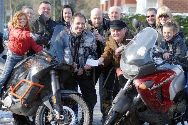 Motorcycle Club members present a cheque to the Blind Society.