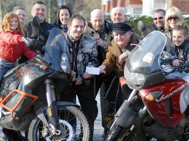Motorcycle Club members present a cheque to the Blind Society.