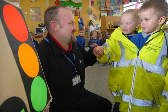 Cayton's Buttercup Nursery receives a visit from road safety officer Andrew Santon. Children Maisie Bell and Daniel Arnell try a safety jacket on for size.