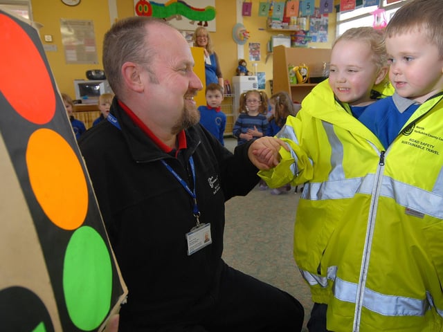 Cayton's Buttercup Nursery receives a visit from road safety officer Andrew Santon. Children Maisie Bell and Daniel Arnell try a safety jacket on for size.