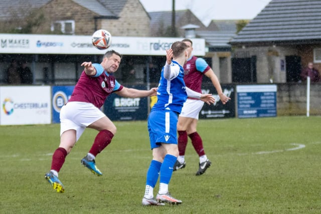 James Knowles looks to clear the ball for Emley. Picture: Mark Parsons