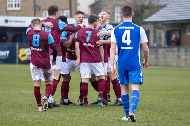 Alex Metcalfe is congratulated by teammates after scoring Emley's second goal. Picture: Mark Parsons