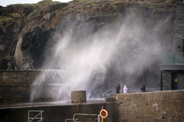 Sea spray engulfs intrepid Whitby locals as Storm Dudley makes its presence felt in North Yorkshire.