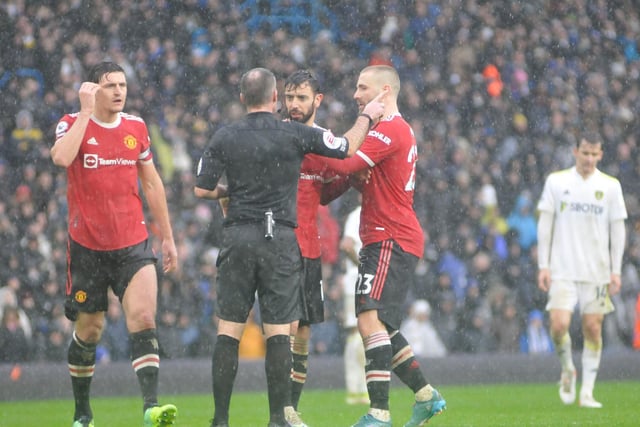 Manchester United players complain to the referee, Paul Tierney.