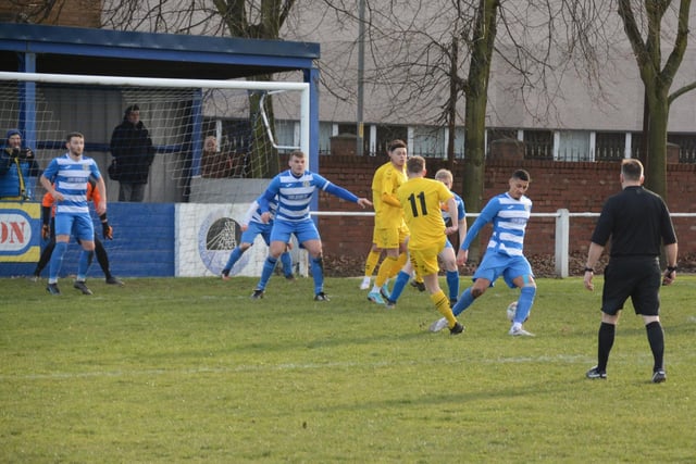 Hallam's Liam Royles is challenged as he looks to get a shot in on the Glasshoughton Welfare goal. Picture: Rob Hare