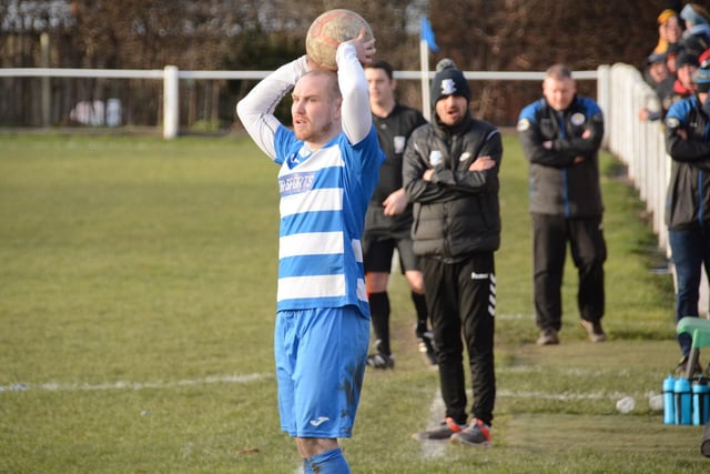 The management teams look on as Matthew Cunliffe takes a throw for Glasshoughton Welfare. Picture: Rob Hare