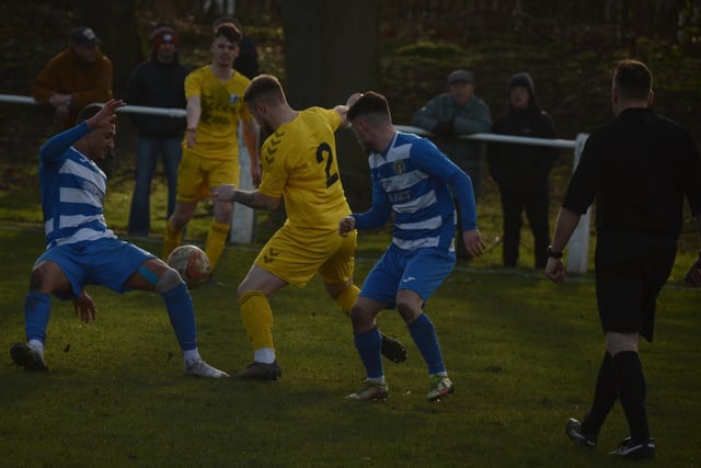 Glasshoughton Welfare players battle for possession with Hallam full-back Jack Brownell. Picture: Rob Hare