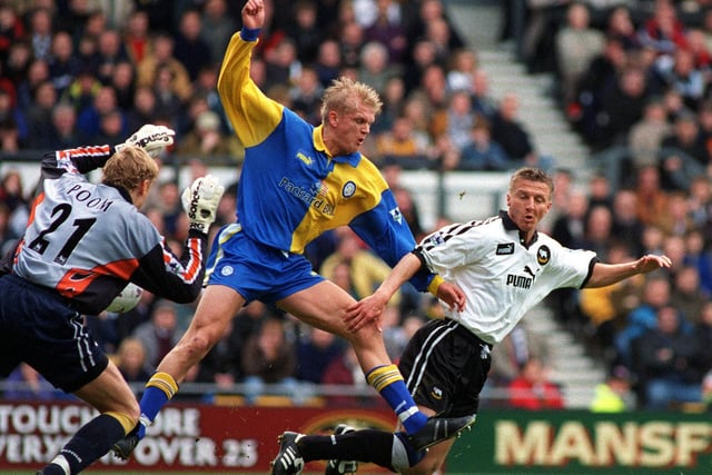 Alfie Haaland puts pressure on Derby keeper Mart Poom and defender Jacob Laursen who conceded an own goal to put Leeds United ahead.