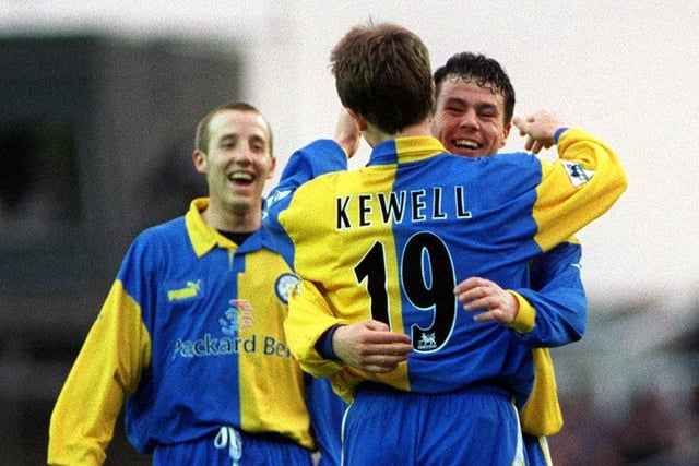 Harry Kewell is congratulated by Ian Harte and Lee Bowyer after scoring Leeds United's fourth goal.