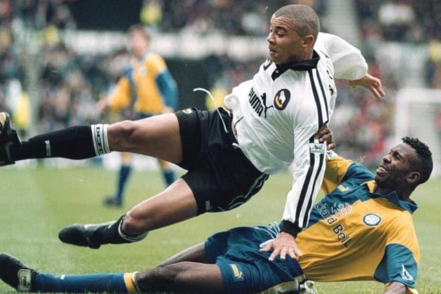 Derby County striker Deon Barton is brought down by Lucas Radebe.
