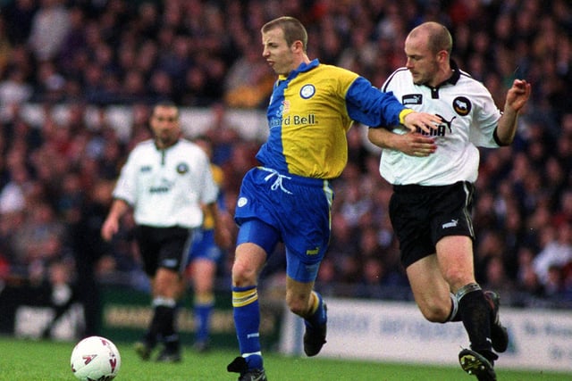 Lee Bowyer holds off Derby County's Lee Carsley.