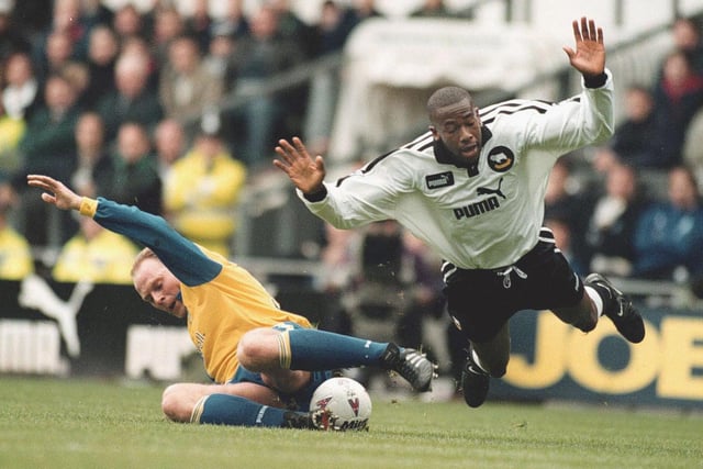 Derby County striker Paulo Wanchope is felled by Robert Molenaar.