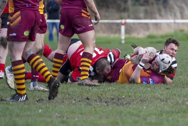 A Wigan St Judes player is stopped by Knights tacklers. Picture: Scott Merrylees