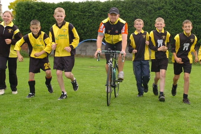 Kev Batty who is doing a sponsored bike ride from Wakefield to Paris and back, is pictured with members of the Wrenthorpe Rangers Junior football club, who have raise £1,250. Left to right, Emily Binks, Jacob Rayner, Philip Craske, Andrew Morvan, Jack Hegarty and  Alex Thompson.