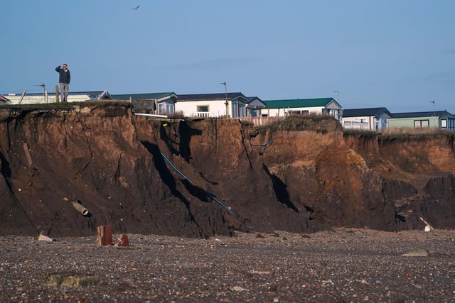Skipsea holiday homes peering over the edge of a cliff shows just how dangerous it has become along the Yorkshire coastline. Local councillors have worked tirelessly for funding and support, describing the situation as it was here in 2020 as 'devastating'.  Owen Humphreys/PA Wire