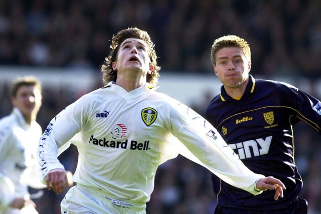Harry Kewell looks up for the ball as Wimbledon's Trond Andersen follows in behind.