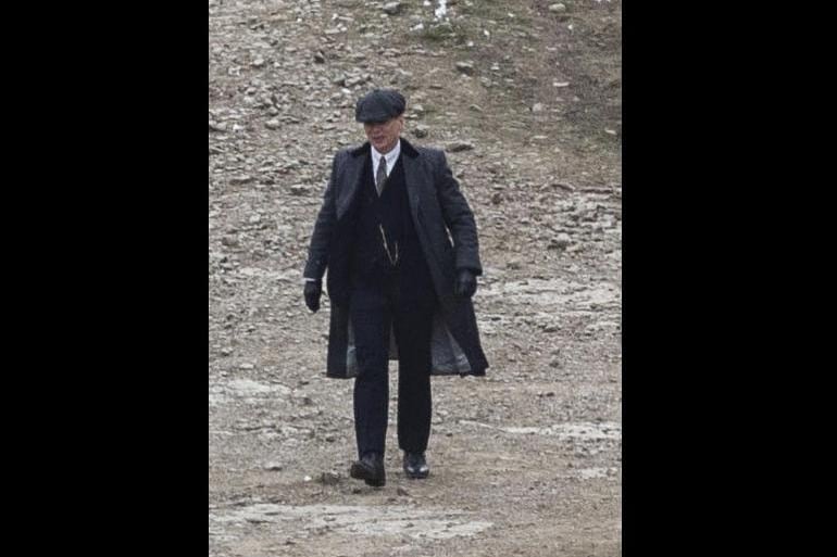 The actor, who plays main character Tommy Shelby, was spotted strutting in his iconic tweed suit, heavy wool dark coats, penny collar shirt and his famous peaked cap.
