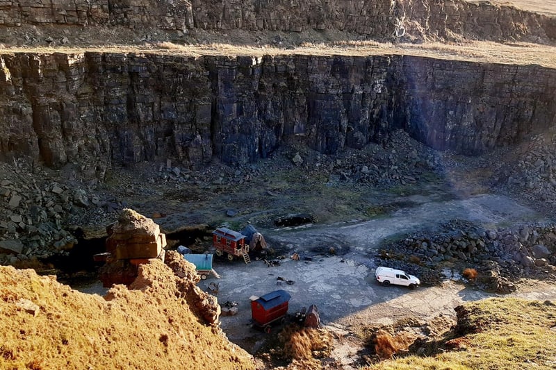 Vans belonging to the film crew could be spotted amongst the dramatic scenery of the quarry