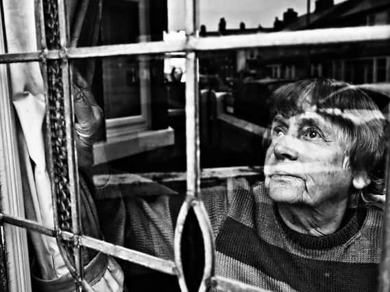 A powerful image of a woman glancing from a window in this Blackpool student's photograph. Photo by: Sammy Hall.