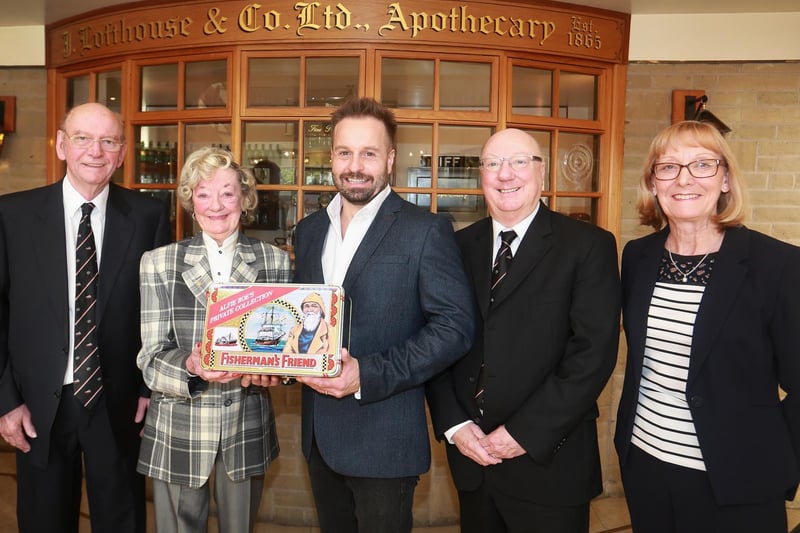 Alfie Boe receiving a commemorative tin of Fisherman's Friend from Tony, Doreen, Duncan and Linda Lofthouse at the factory in 2016.  Photo: leeboswellphotography.com
