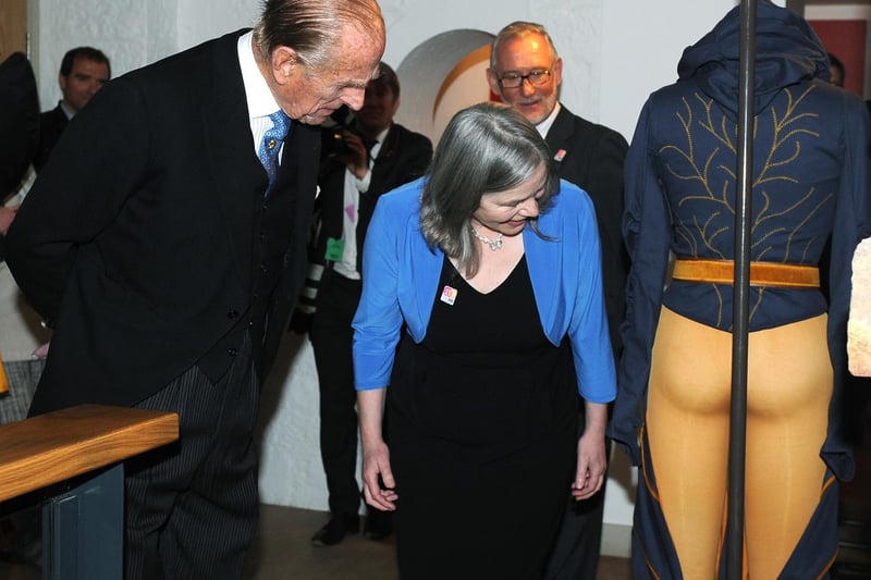 Prince Philip, accompanied by Janet Barnes, CEO of York Museums Trust, studies a mannequin on display as part of an exhibition of medieval costumes designed by York College students in April 2012.