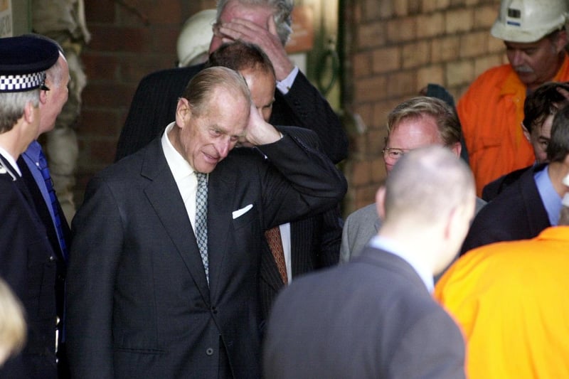 In July 2002, Prince Philip visited the National Coal Mining Museum in Overton. He is seen here brushing back his hair after removing a miner's hat and lamp he had worn while down a mine shaft.