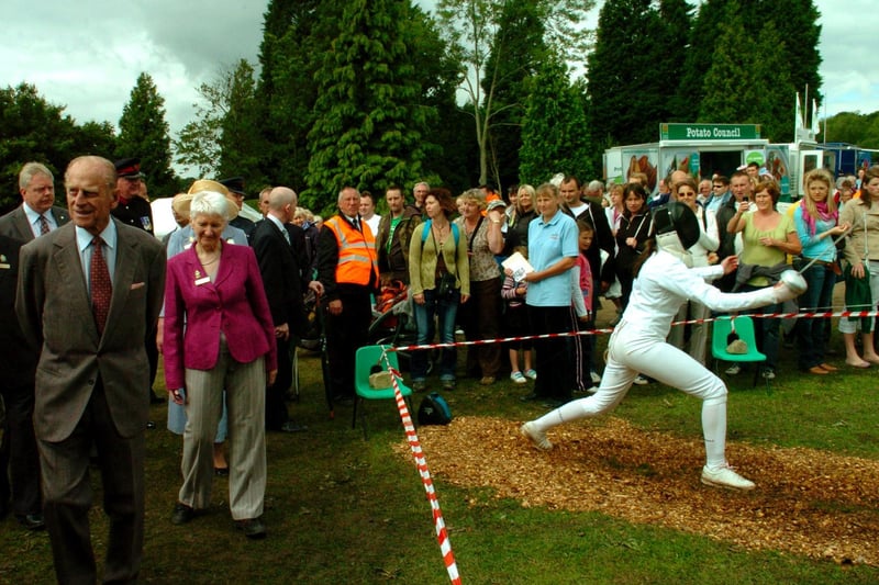 The Duke of Edinburgh passes the North Yorkshire Sport stand, at the 150th Great Yorkshire Show in Harrogate with a fencer in action.