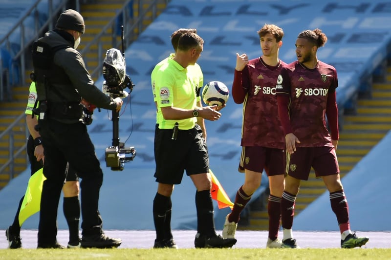 Diego Llorente and Tyler Roberts complain to referee Andre Marriner at half-time over his decision to reduce Leeds to 10 men just seconds before the interval.