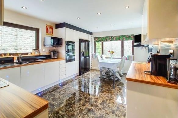 The kitchen is full of practical storage and integrated appliances, including two pull out shelving units and a built in wine storage. The room, which benefits from under flooring heating, also looks out onto the garden.