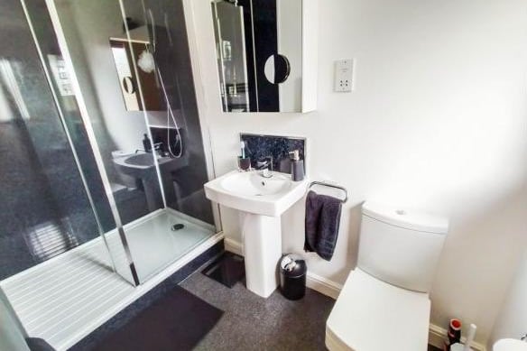 The en-suite bathroom is modern and high quality with a rainforest shower, pedestal sink and toilet.