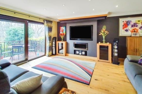 The living room lounge area is on the ground floor level, with patio doors that open onto the balcony, giving great views of the garden. It has an oak flooring and electric fire, and the bi-fold doors can be opened to make the room an open plan living dining area.