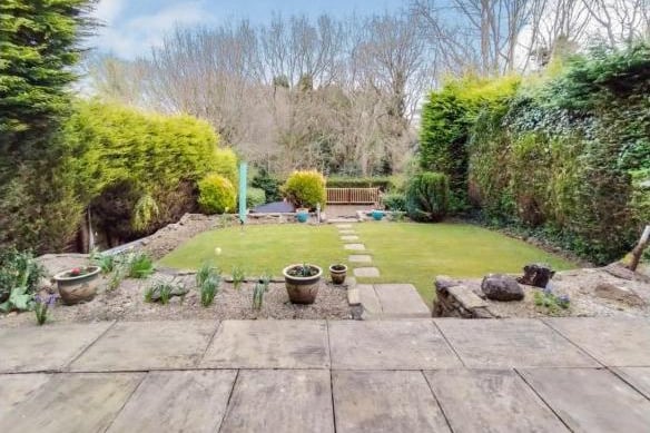 Steps lead down to a patio and a sunken garden and there is also a decked terrace and patio.  The garden has access via a gate to the woodland beyond.