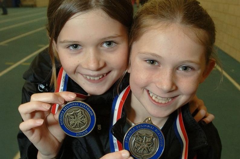 Wigan Harriers Alice Fitton, 11, and Abigail Fitton, nine, from Atherton, who won first and second, respectively in the Year 7 and Year 5 age groups of the North West Schools Regional Biathlon, with their medals at Robin Park in 2005.
