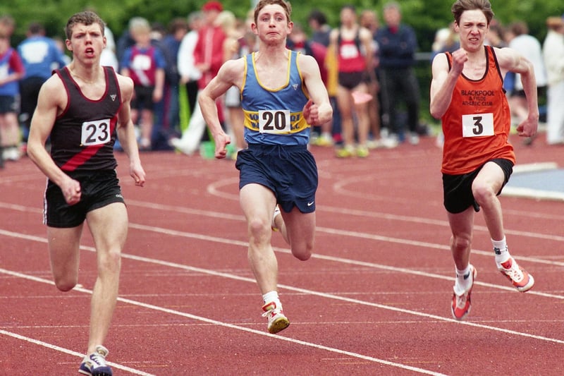 Wigan Harriers' Neil Martin, (left), on his way to winning his heat of the Under 17s men's 100 metres in the first Mid-Lancs League meeting of the season at the Robin Park Arena on Saturday 17th of April 1999.
