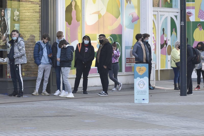Shoppers line up in the streets in Leeds city centre