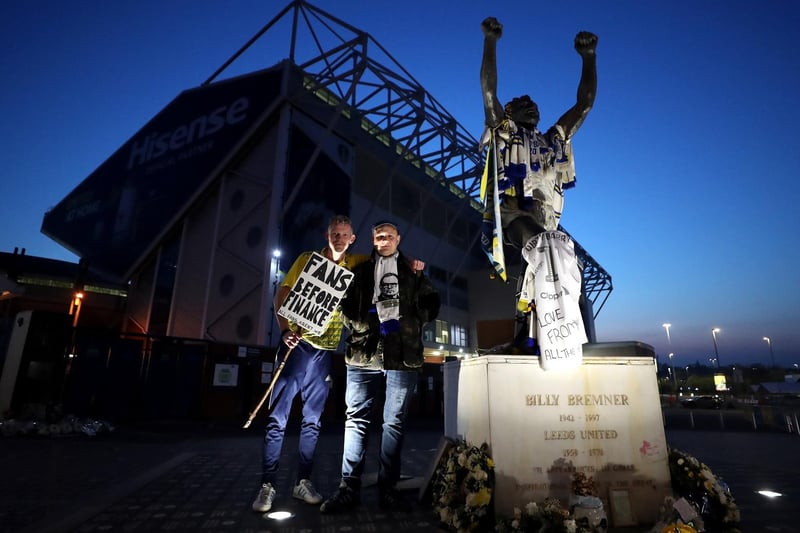 Leeds United fans, next to the statue of former Leeds United player Billy Bremner.