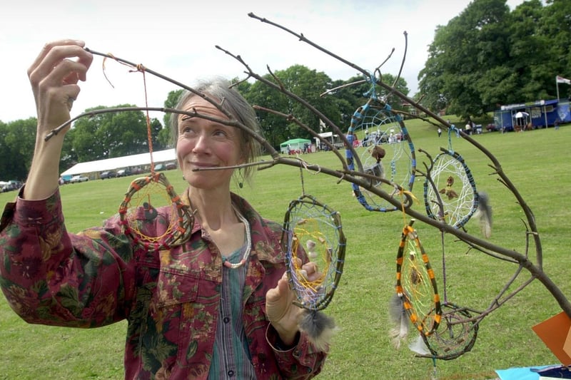 Pictured is Chris Western, from Spiral Crafts, constructing a Dream-Catcher tree at Beeston Mela in July 2001.