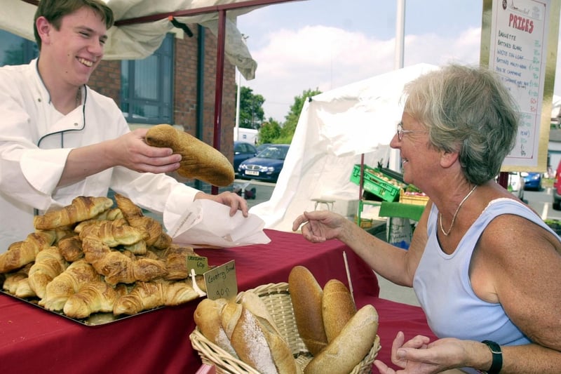 June 2003 and people power helped the farmers market become a permanent fixture in the town until the autumn. Pictured is Anthony Lecaude from Garforth's Dumouchel Patisserie selling French bread.