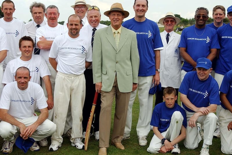 Geoffrey Boycott is pictured with the teams after a charity cricket match for Cancer Research at Rothwell Cricket Club in June 2003.