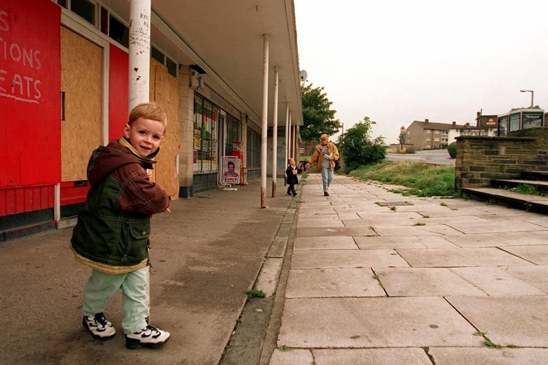 Perry Beal swings around a steel pillar outside the small row of shops on the Swinnow estate in October 1996.