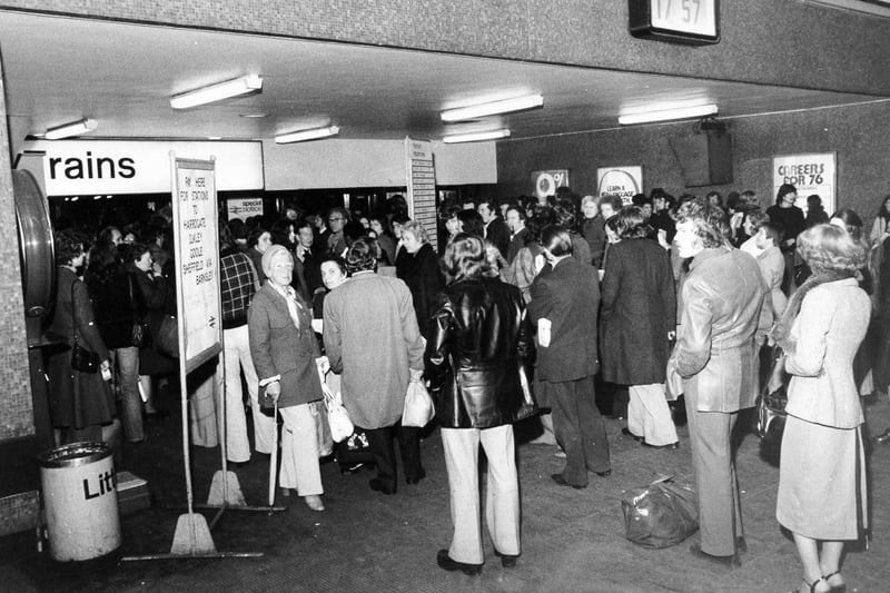 Passengers wait at the barriers in Leeds City Station after a bomb alert in November 1975.