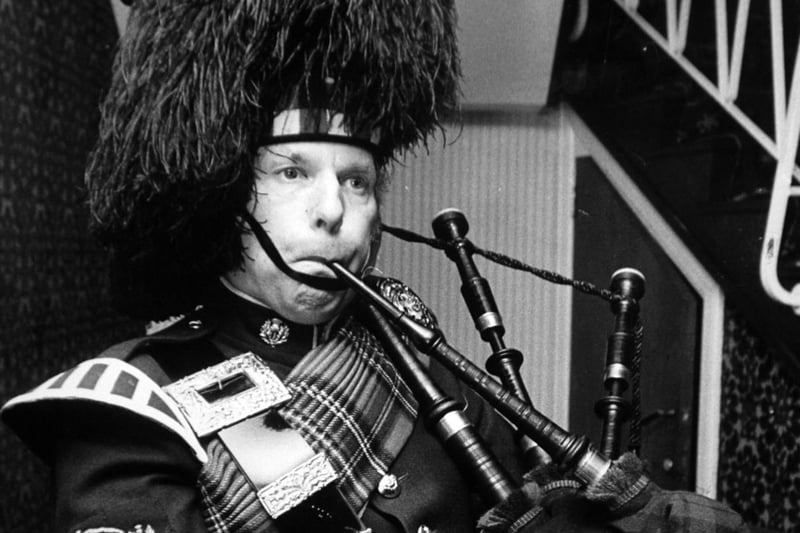 January 1975 and Pipe Major J. Nixon of the City of Leeds Pipe Band tuning up his instrument before leading in the haggis.