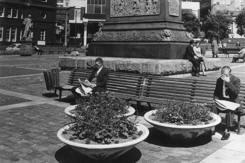 People sit on benches all around the Black Prince in the 1960s. Supporting the Prince is a pedestal with relief panels, depicting land and sea battles, evoking his heroism against France.