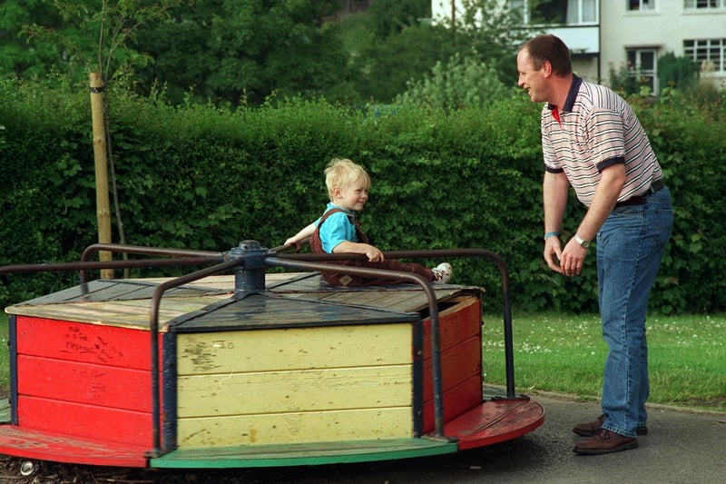 Joe Geekie with his son Joseph enjoying a ride on a roundabout at Springhead Park in June 1997.